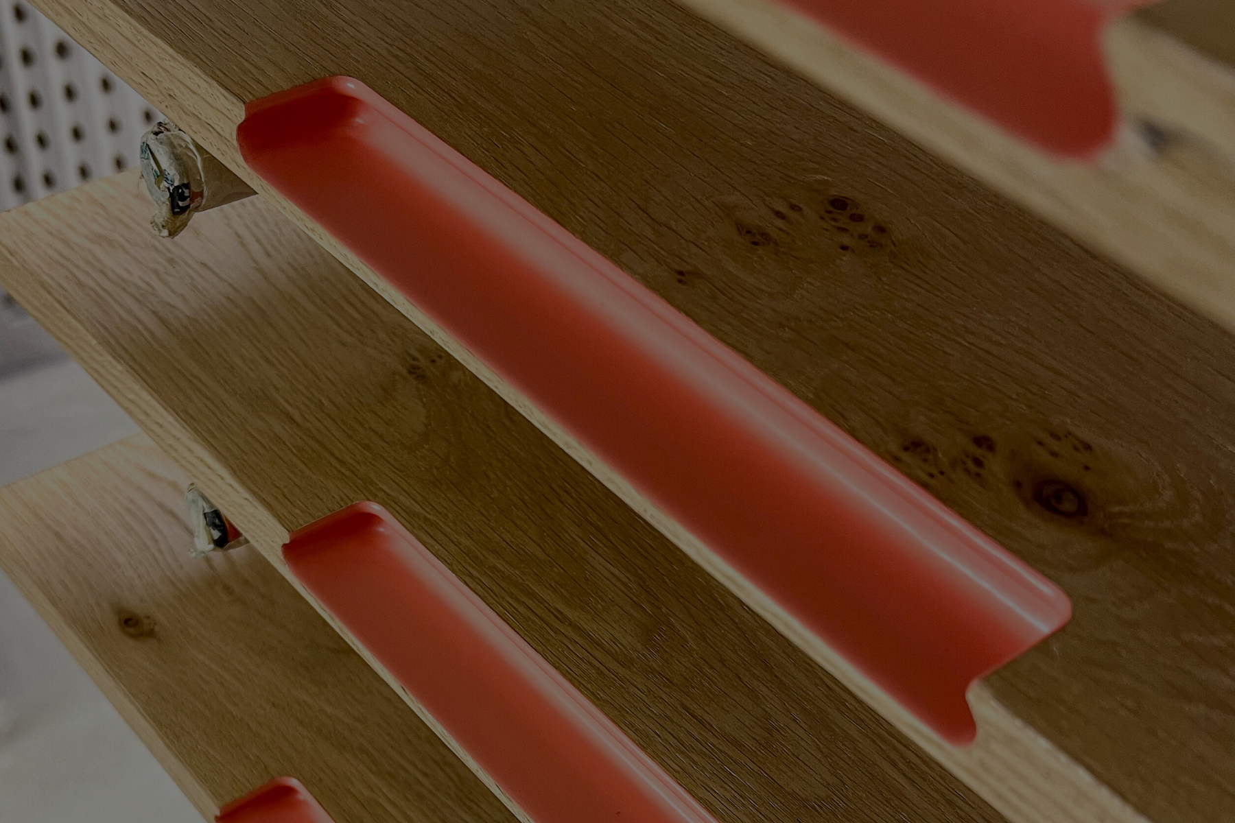 Spray finished drawer fronts that have been dried on a drying rack.
